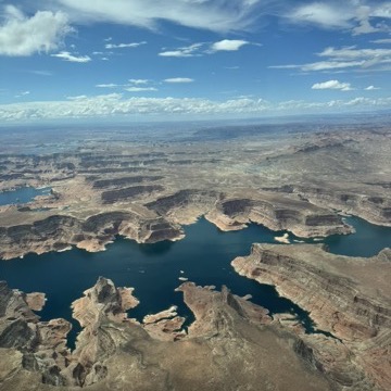 Aerial view of a desert lake and red rock canyons